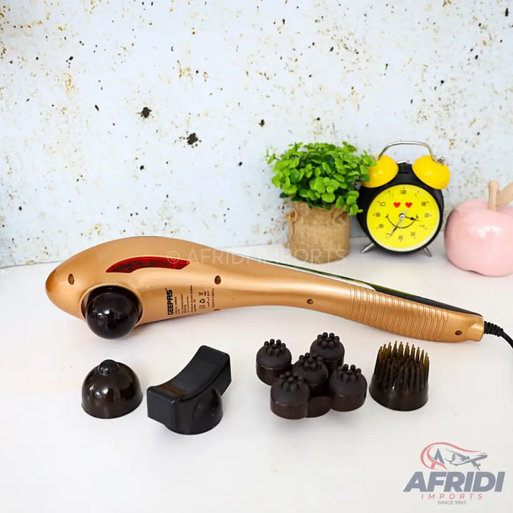 A golden handheld massager with interchangeable heads.