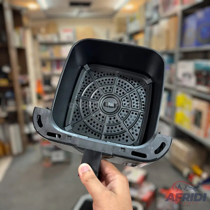An air fryer basket with a removable perforated crisping plate.