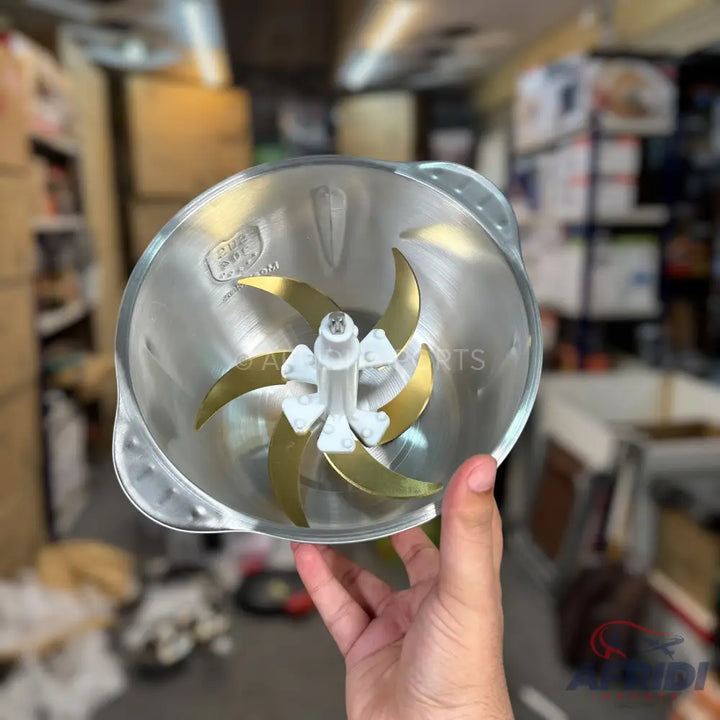 A clear glass chopper bowl with a six-blade gold-colored stainless steel chopping attachment.