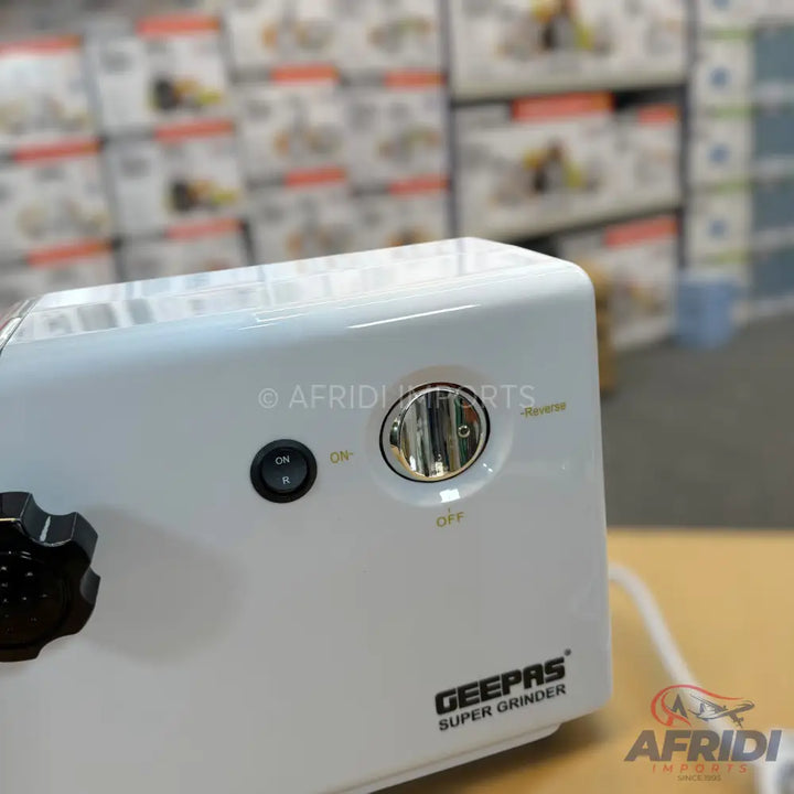 White electric grinder with on/off switch and rotary selector.