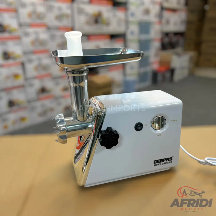 White electric meat grinder with a chrome-plated grinding head and a black control knob.