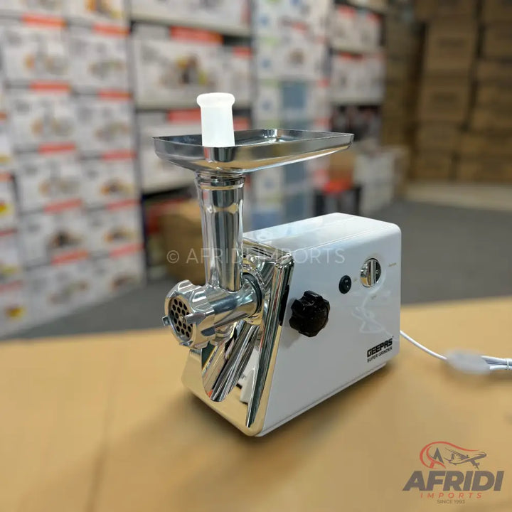 White and chrome electric meat grinder with a feeding chute.