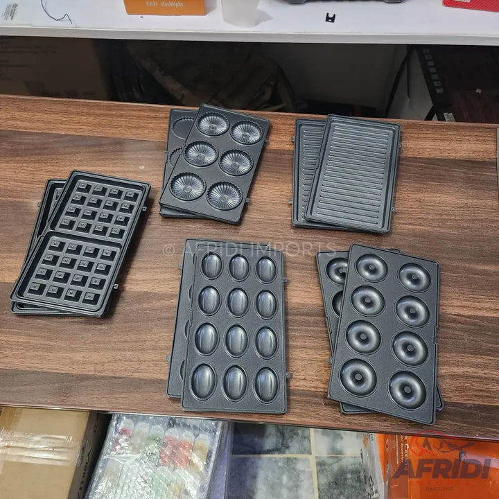 Various interchangeable cooking plates for a multi-functional kitchen appliance.