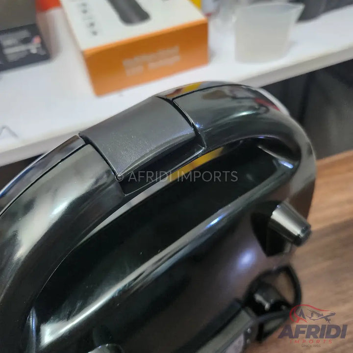 A sleek black handheld electric whisk or mixer.