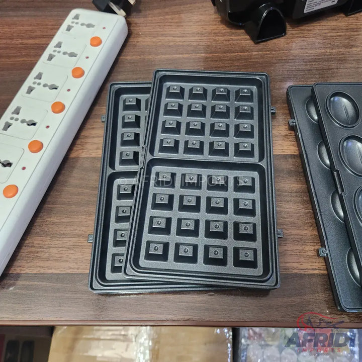 Interchangeable waffle and pancake iron plates.