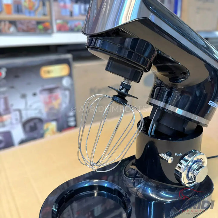 Black stand mixer with a stainless steel whisk attachment.