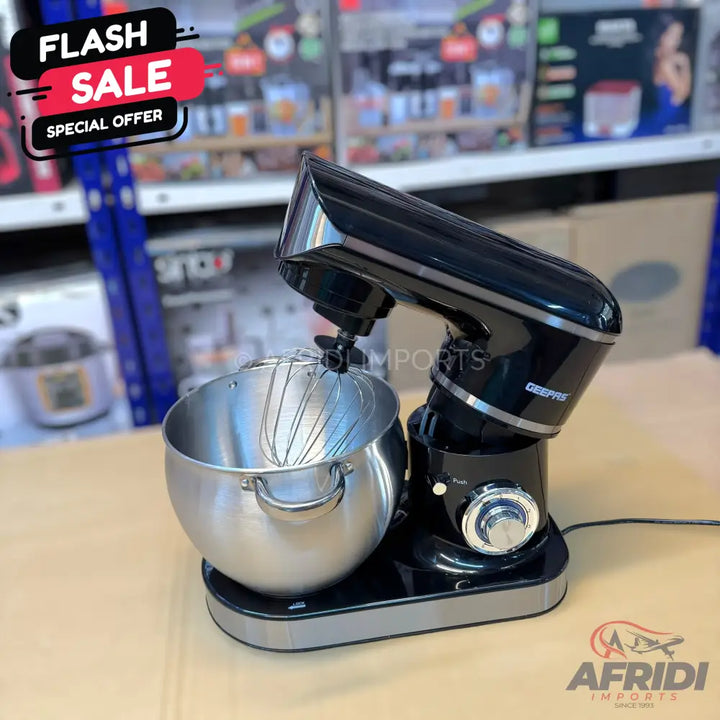 A black stand mixer with a stainless steel bowl and whisk attachment.