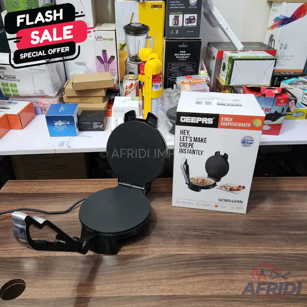 An open black electric chapati and crepe maker with its product box.
