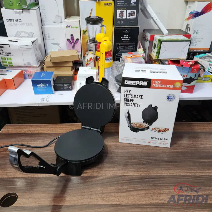 A black electric chapati and crepe maker with an 8-inch non-stick cooking surface.