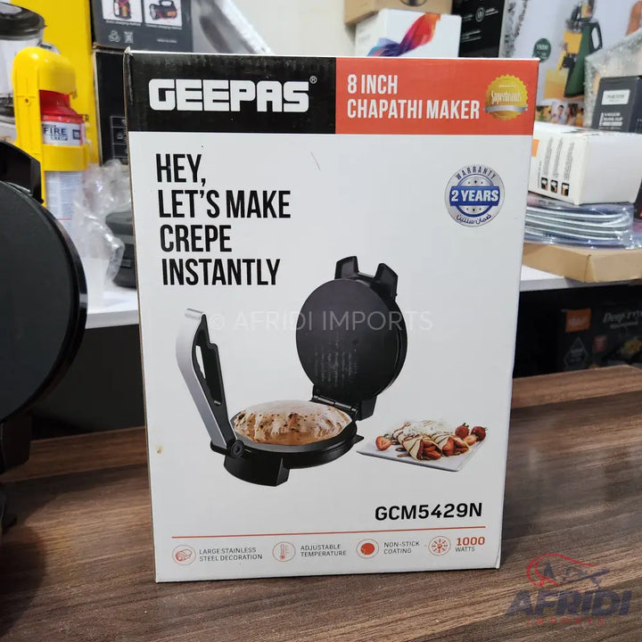 A black 8-inch chapati and crepe maker with 2 years warranty and 1000 watts power.