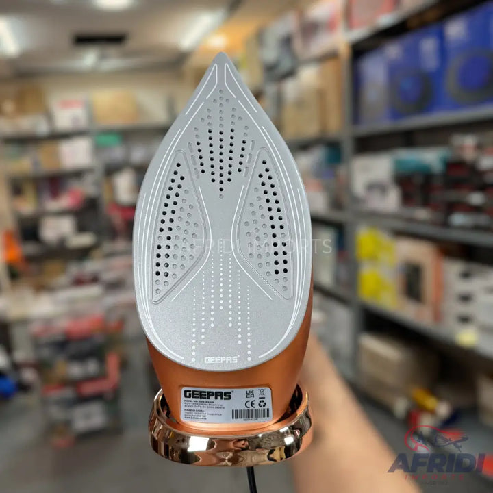 Copper-colored cordless steam iron with a white ceramic soleplate.