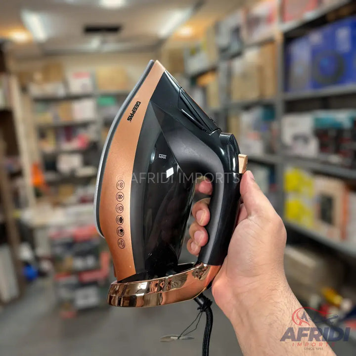 A black and copper steam iron with multiple heat settings.