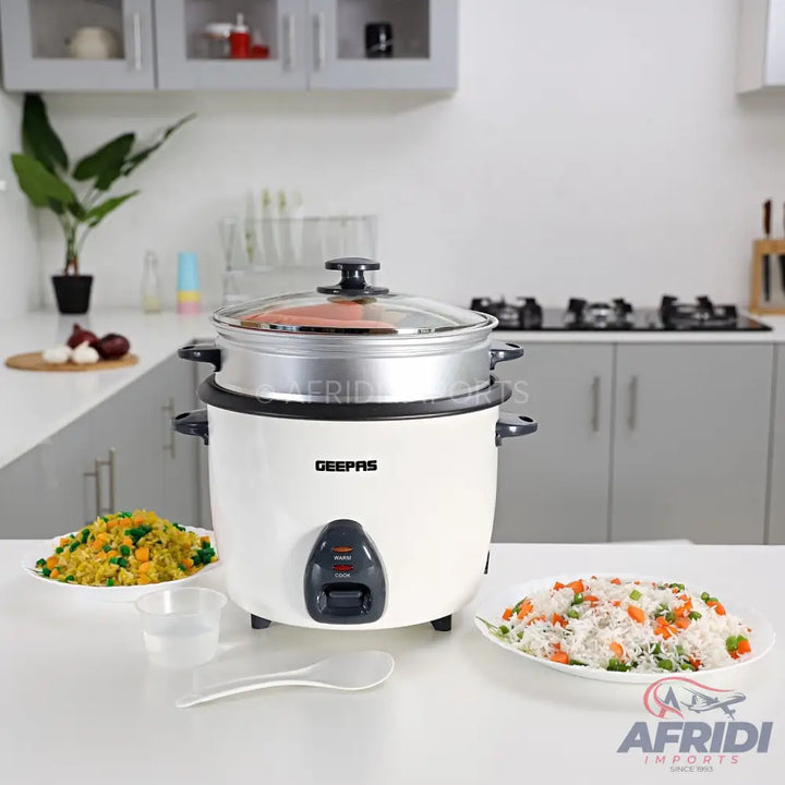 White rice cooker with a steaming tray and glass lid.