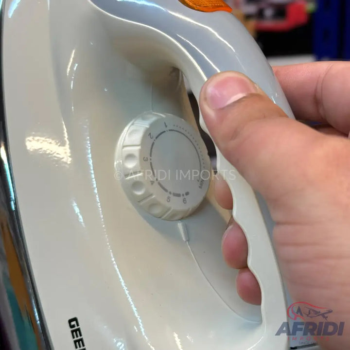 White electric clothes iron with a temperature control dial.