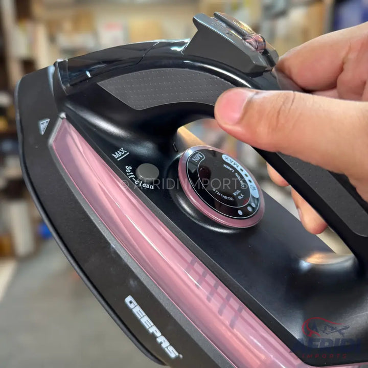 Black and rose gold steam iron with adjustable temperature settings.