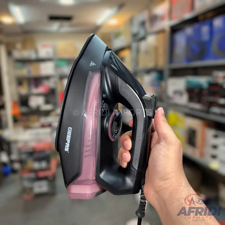A black and pink steam iron with a textured handle.