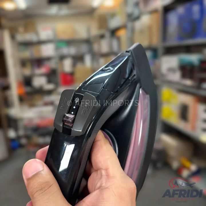 A black and purple steam iron with adjustable settings.