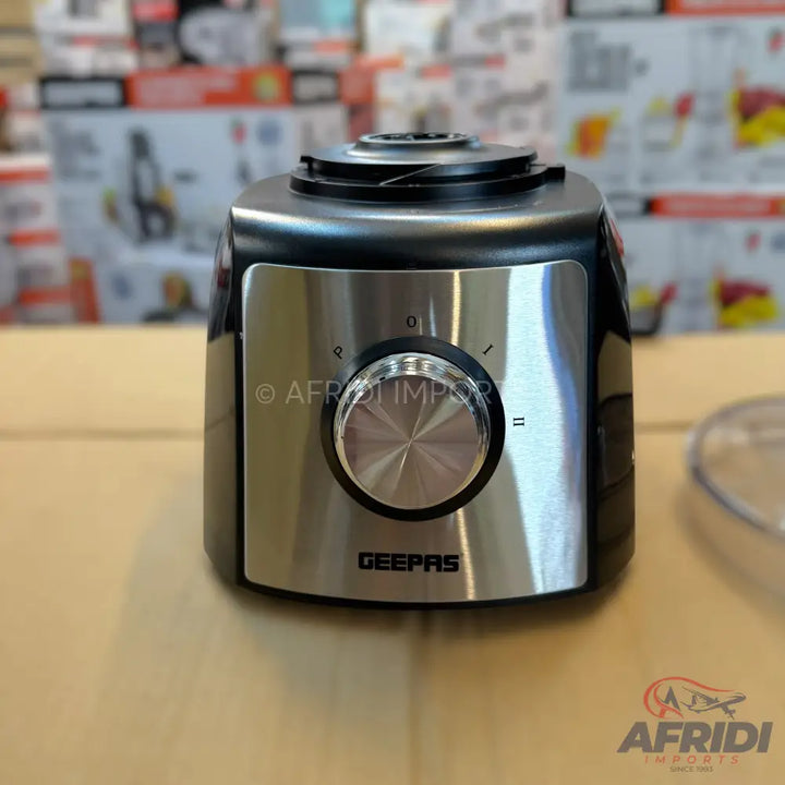 A black and silver food processor base with a control knob.