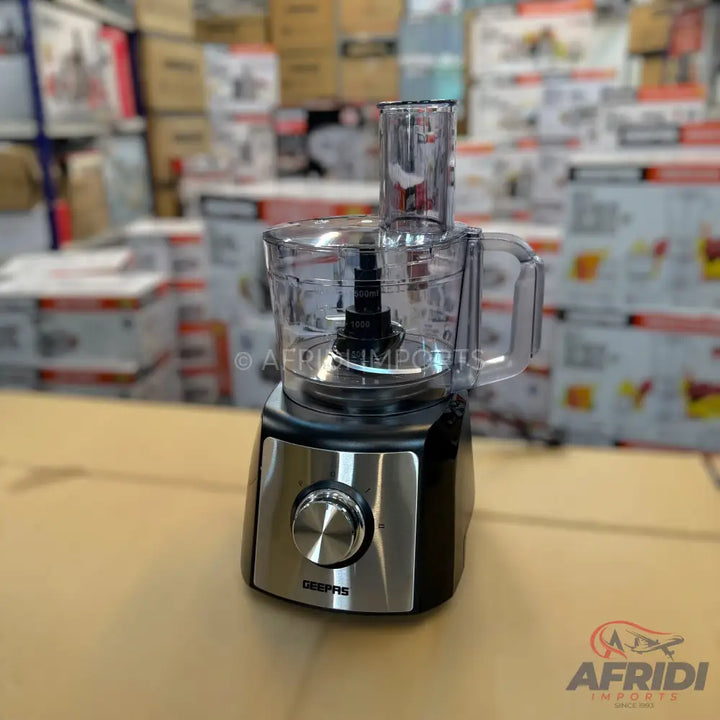 Black and silver food processor with a clear plastic bowl and lid.