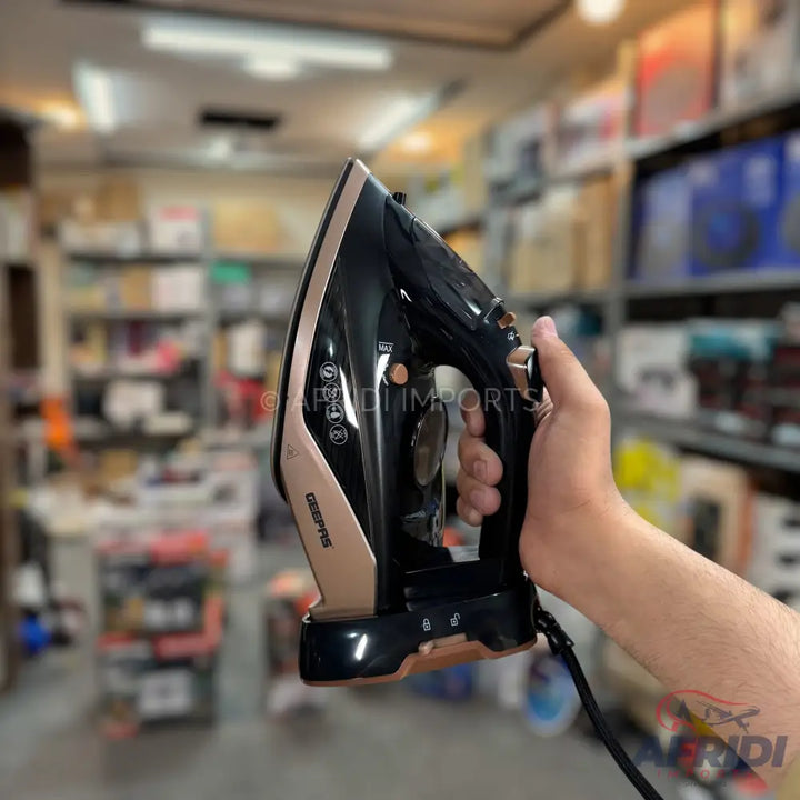 Black and rose gold steam iron with a pointed soleplate and a textured grip handle.