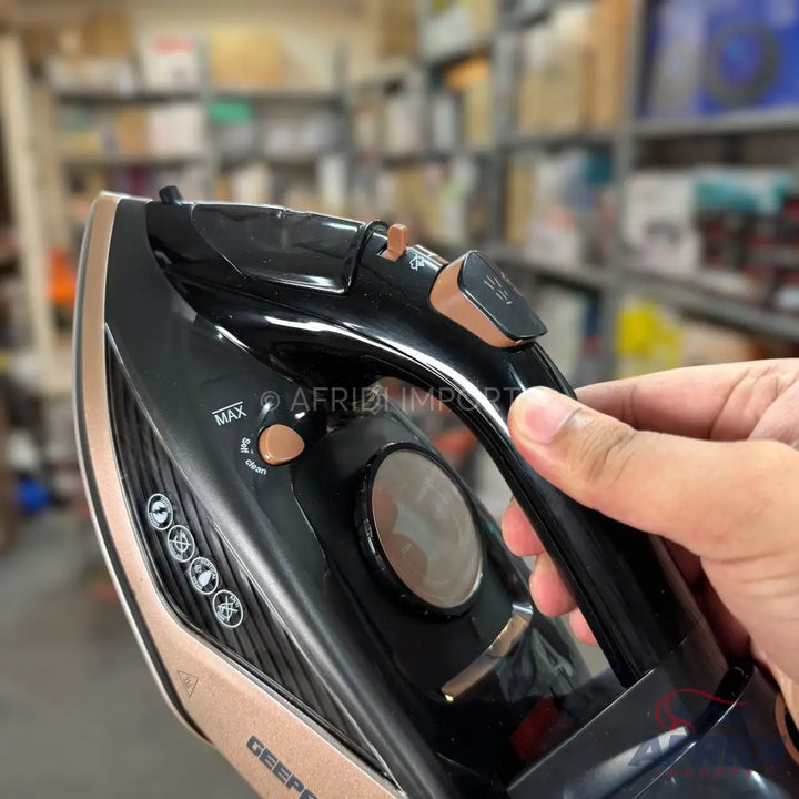 A black and rose gold steam iron with a water level indicator and various fabric settings.