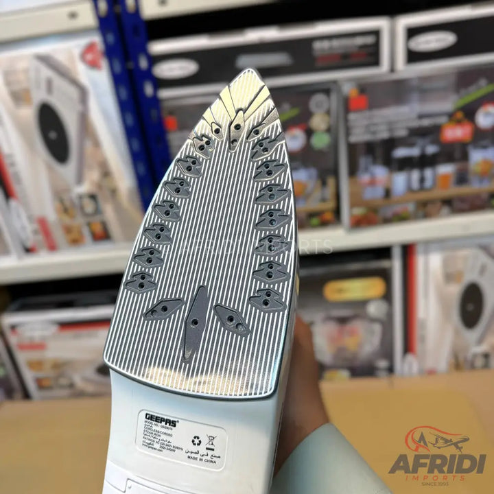 White steam iron with a ridged soleplate and steam vents.