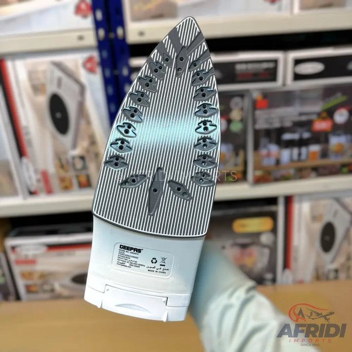 White, cordless travel iron with a ribbed soleplate.