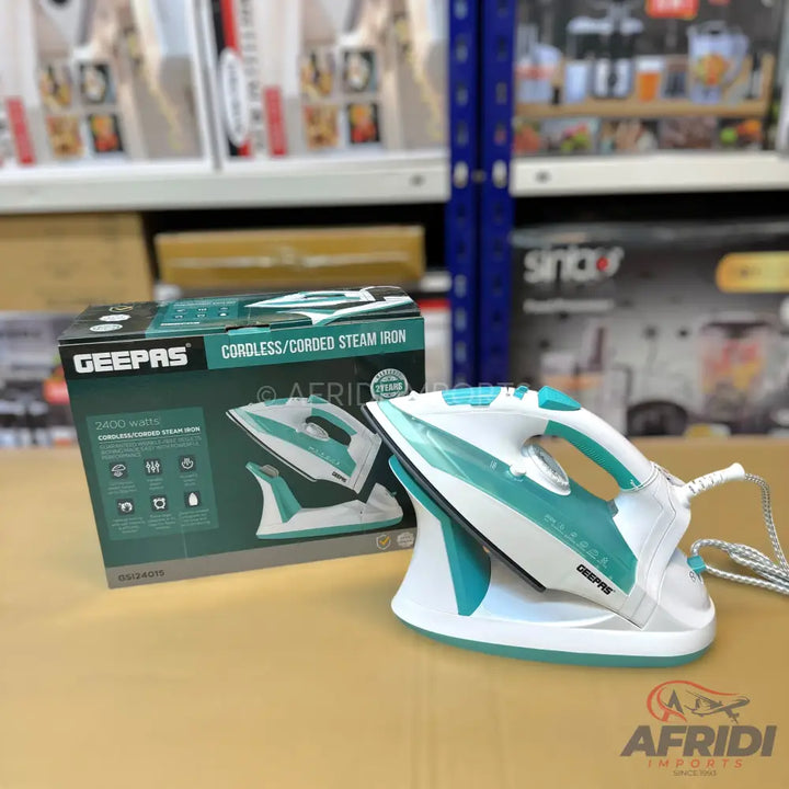 A white and teal cordless/corded steam iron with its charging base and original packaging.