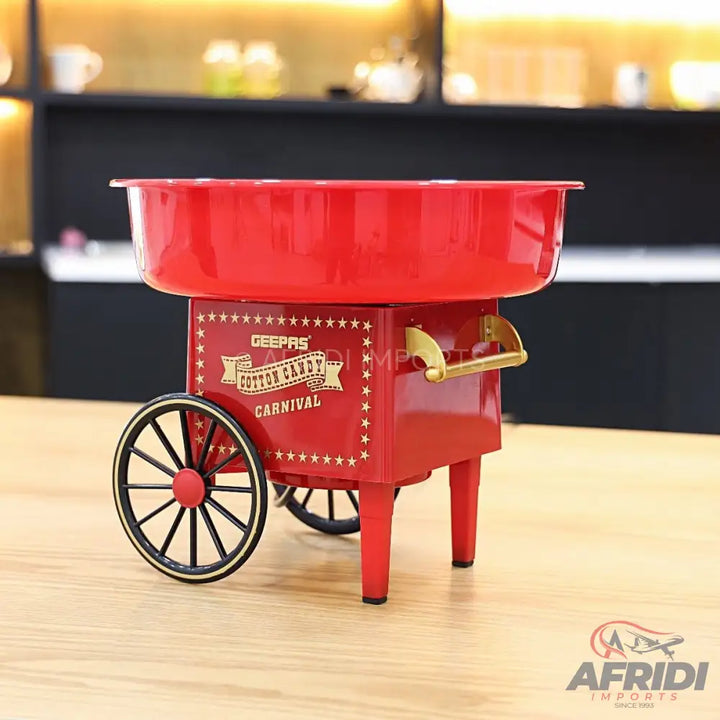 Red countertop cotton candy machine with wheels.