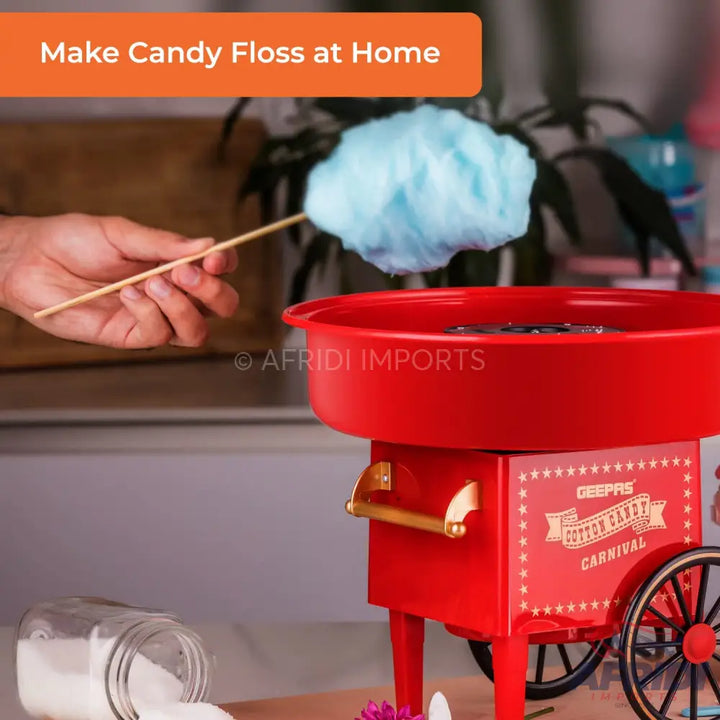Red cotton candy machine with a bowl and wheels.