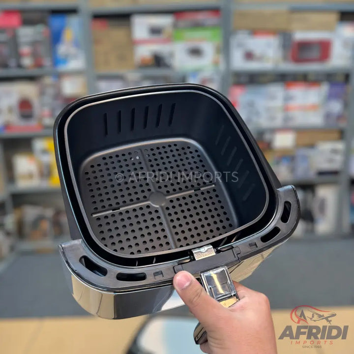 Black air fryer basket with a removable perforated crisping plate and handle.