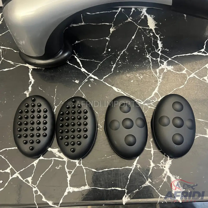A handheld electric massager with four interchangeable massage heads for different sensations.