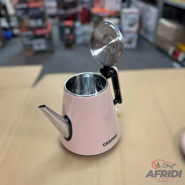 Pale pink electric kettle with a stainless steel spout and interior.