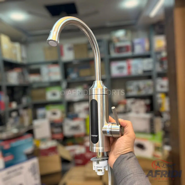 Stainless steel instant hot water dispenser with a single lever handle and a digital temperature display.