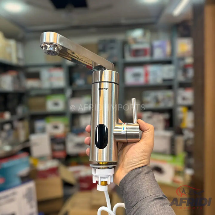 A modern, brushed-steel instant hot water faucet with a black digital display and a single handle.
