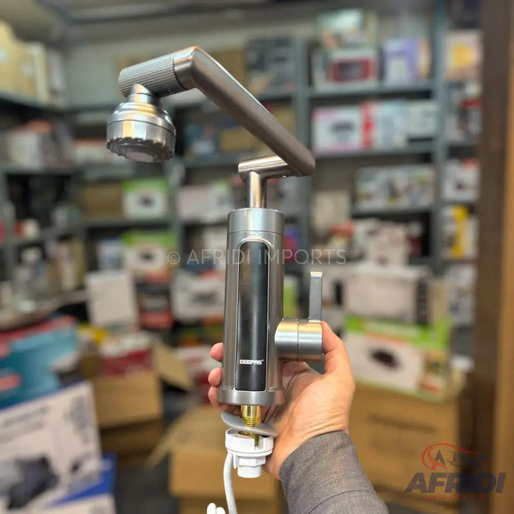 A silver-colored instant water heater faucet with an adjustable shower head.