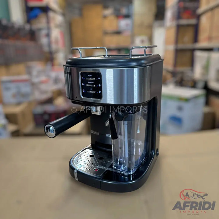 Stainless steel and black espresso machine with a frothing wand and a transparent water reservoir.