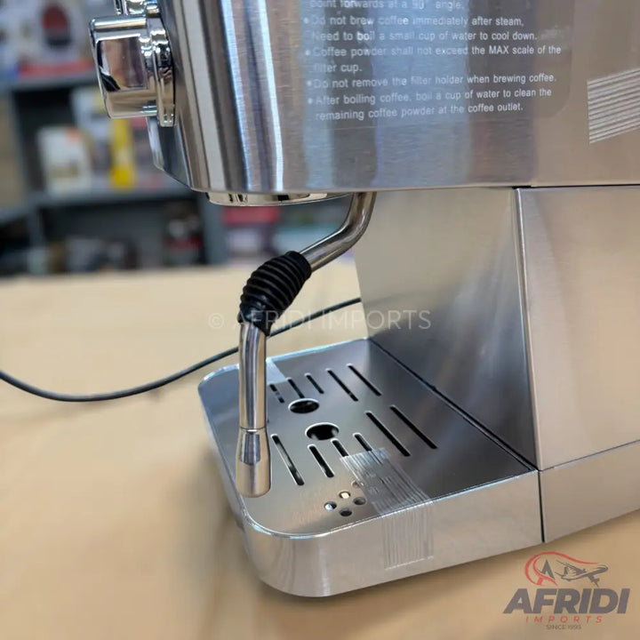 Stainless steel espresso machine with a steam wand and drip tray.