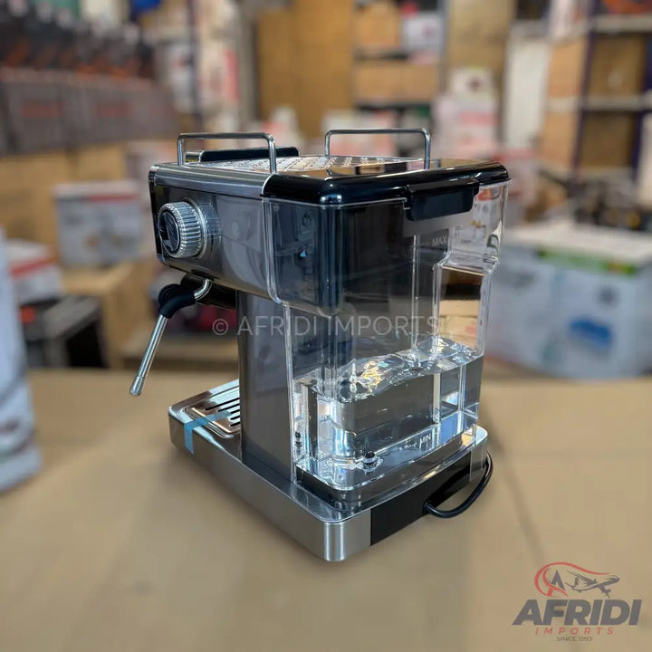 A sleek, silver and black espresso machine with a clear water reservoir and a steam wand.