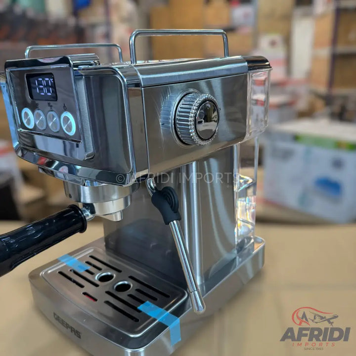 A stainless steel espresso machine with a digital display and steam wand.