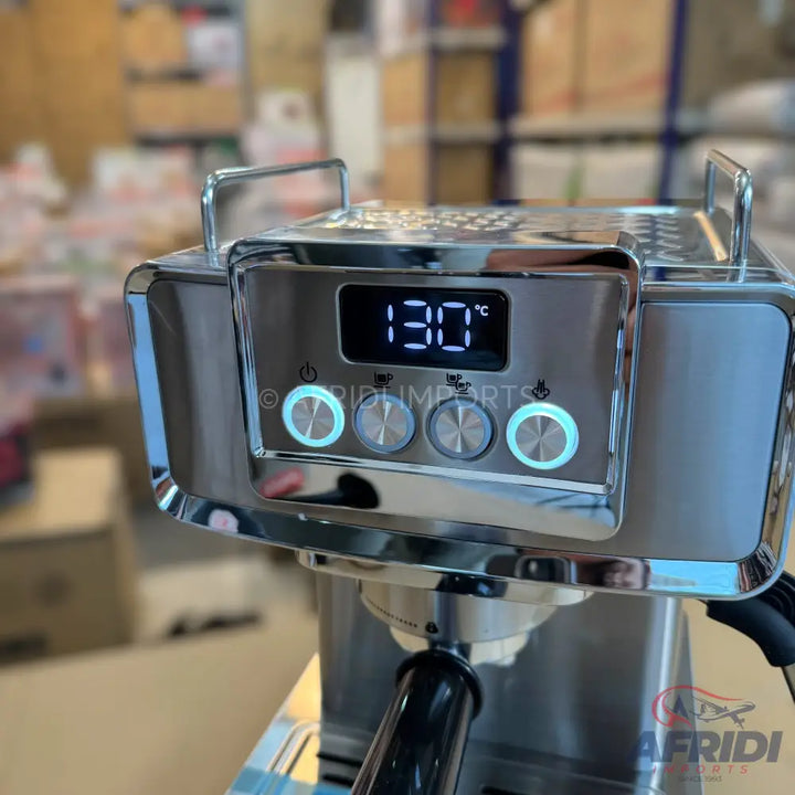 A chrome-finished espresso machine with a digital temperature display showing 130°C and illuminated control buttons.
