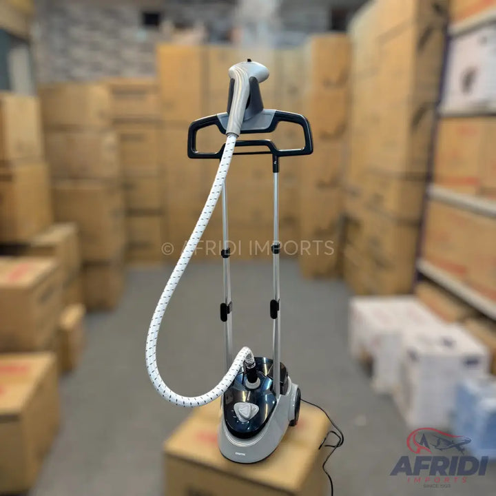Gray and black garment steamer with a white, flexible hose and a hanger attachment.