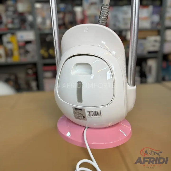 A white garment steamer with a pink base and a visible water tank.