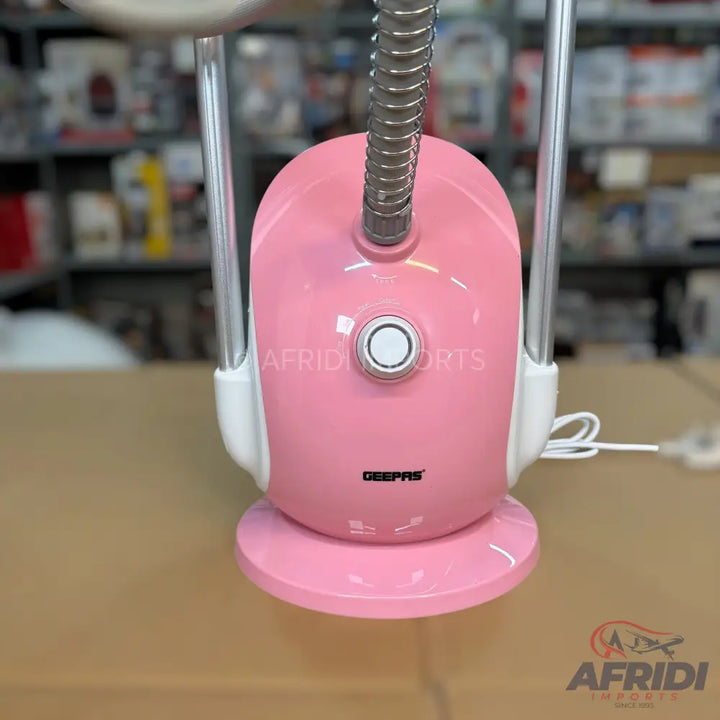 Pink and white garment steamer with a flexible hose and an adjustable pole.