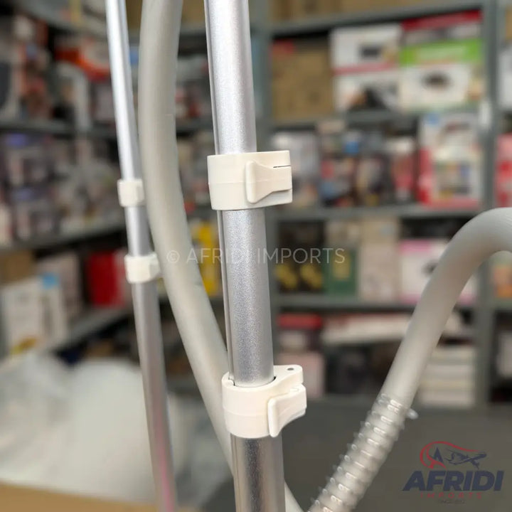 A height-adjustable garment steamer with a flexible hose.