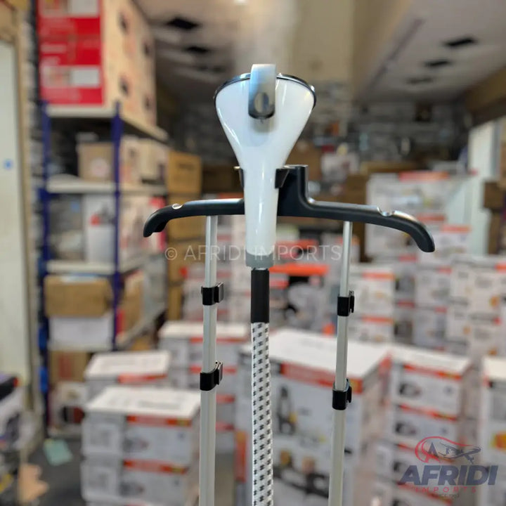 White and grey garment steamer with a black hanger attachment.