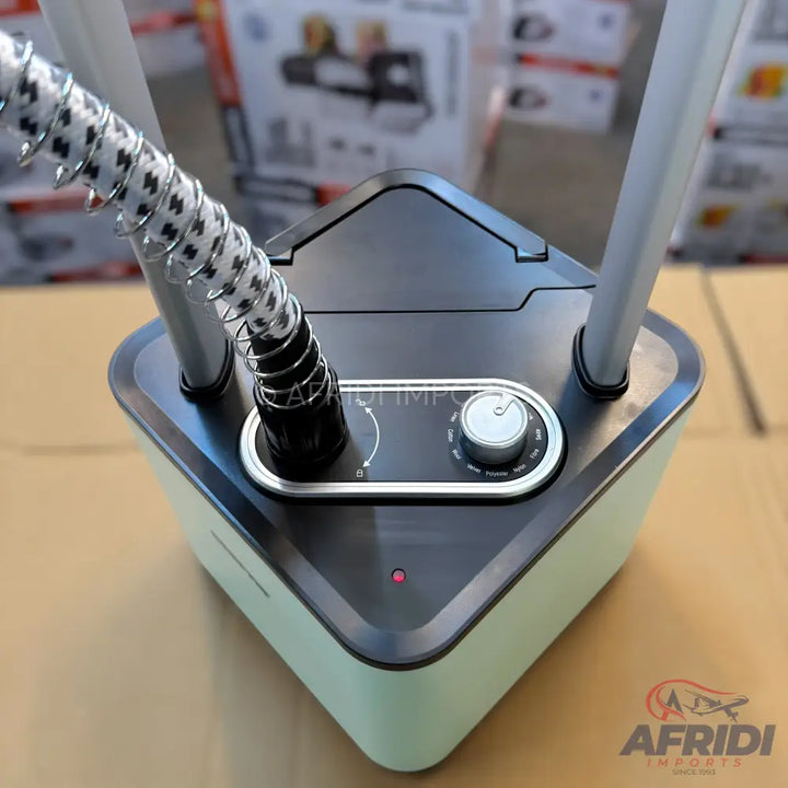 A light green and black garment steamer with a flexible hose and a control dial.