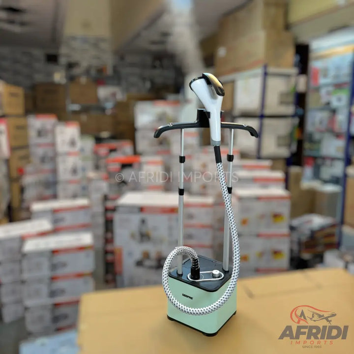 A light green and black garment steamer with an adjustable stand and a steaming head.