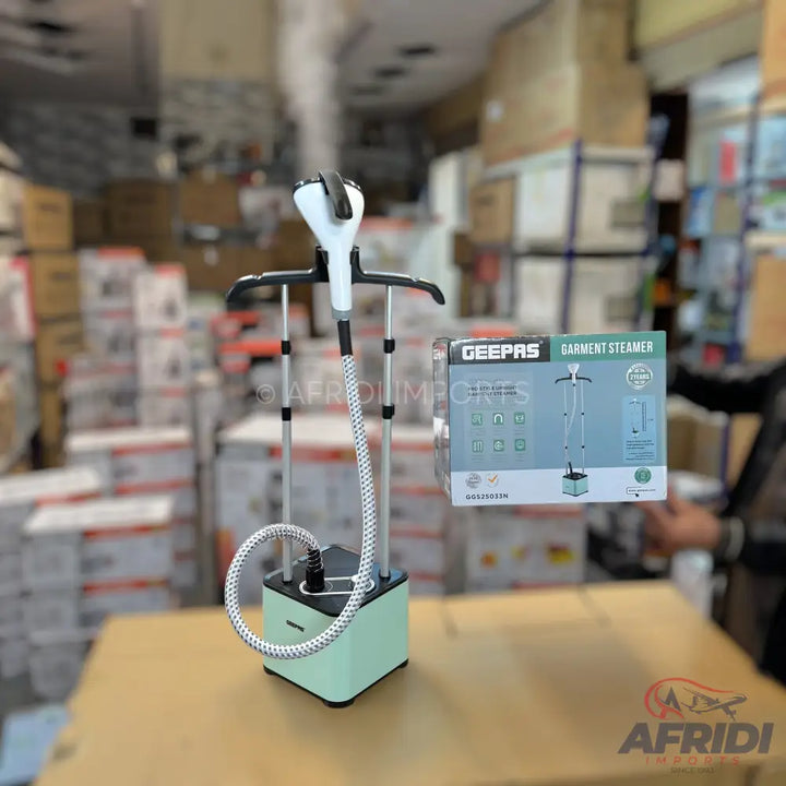 Light green and white upright garment steamer with a hanger attachment.