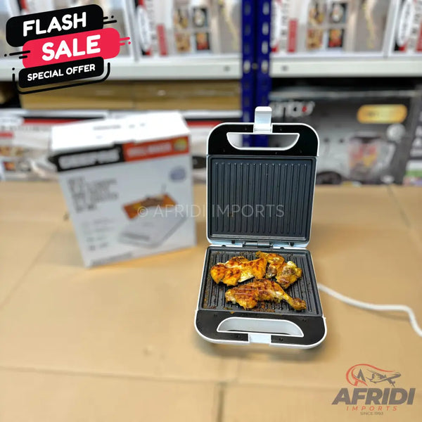 An open electric grill with several pieces of cooked chicken inside.